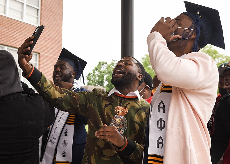 In this May 2021 photo, Marshall Reed, center, leads "Scholars," a celebratory chant, with his Alpha Phi Alpha brothers Saturday at Lincoln University's graduation ceremony outside the Richardson Fine Art Center. Raphael "Raph" Green, right, said during his time as Mister Senior, a position that represents the student body, he saw positive responses from students from the feeling of community that was maintained on campus. "They said this year was one of their best years, even with COVID-19," Green said. (India Garrish/News Tribune photo) 