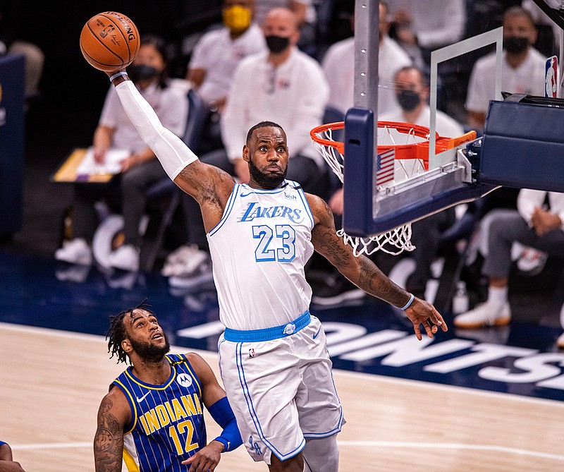 Los Angeles Lakers forward LeBron James (23) goes up high to dunk the ball during the first half of an NBA basketball game against the Indiana Pacers in Indianapolis, Saturday, May 15, 2021. (AP Photo/Doug McSchooler)