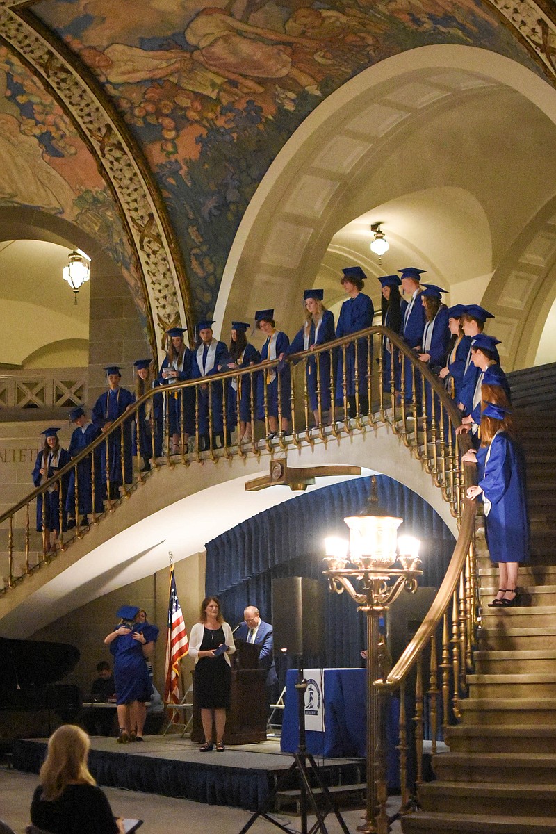 India Garrish/News TribuneLighthouse Preparatory Academy seniors receive their diplomas, then line up on the second floor of the Capitol Sunday during their graduation ceremony at the state capitol. Melissa Hatfield, seated on the left, gave the charge to the class of 2021. She used the experiences of John Landy, an Australian middle-distance runner, to remind them to run life well, and when they get distracted, that there is always another race. “Try not to get distracted by what doesn’t really matter,” Hatfield said. “Keep running, eyes and heart focused on what matters most.”