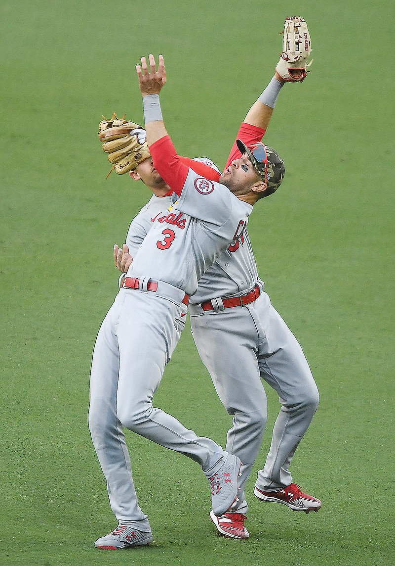 Cardinals right fielder Dylan Carlson (3) and second baseman Max Moroff collide in an attempt to catch a ball during the seventh inning of Sunday night's game against the Padres in San Diego.