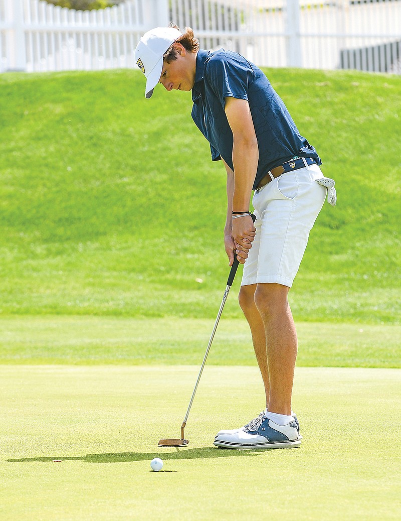 Archer Schnieders of Helias rolls a putt to the hole during a tournament this season at Meadow Lake Acres Country Club.