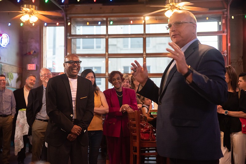 Former City Manager Kenny Haskin laughs as Texarkana, Ark., Mayor Allen Brown reflects on Haskin's love for Henderson State University football during a going-away reception Tuesday evening at Zapata's.