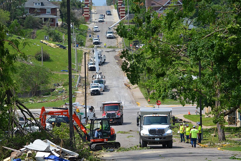 Utility workers remove debris and instal new electrical lines down Jackson Street on Friday, May 24, 2019, along Capitol Avenue as the city began to repair damages caused by the May 22 tornado. 