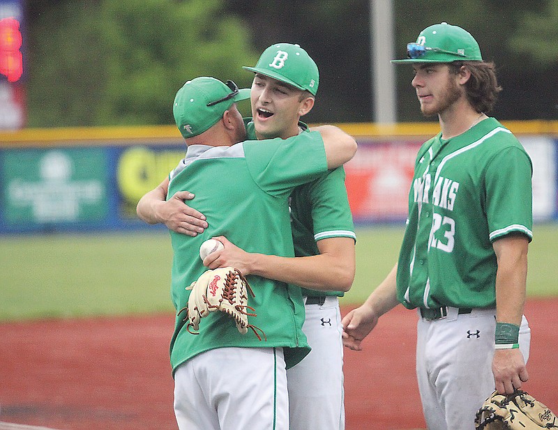 Blair Oaks coach Mike DeMilia (left) hugs pitcher Gavin Wekenborg after he recorded the final out of Thursday's Class 4 District 8 Tournament championship game against Fatima at California.