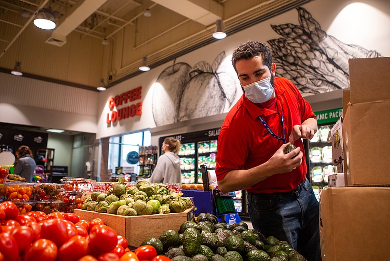 Richmond Center Schnucks Assistant Produce Manager Austin Vonderhaar stocks avocados just before the 5 p.m. rush on Feb. 25, 2021, in Richmond Heights, Mo. in St. Louis County. (Sara Diggins/St. Louis Post-Dispatch/TNS)