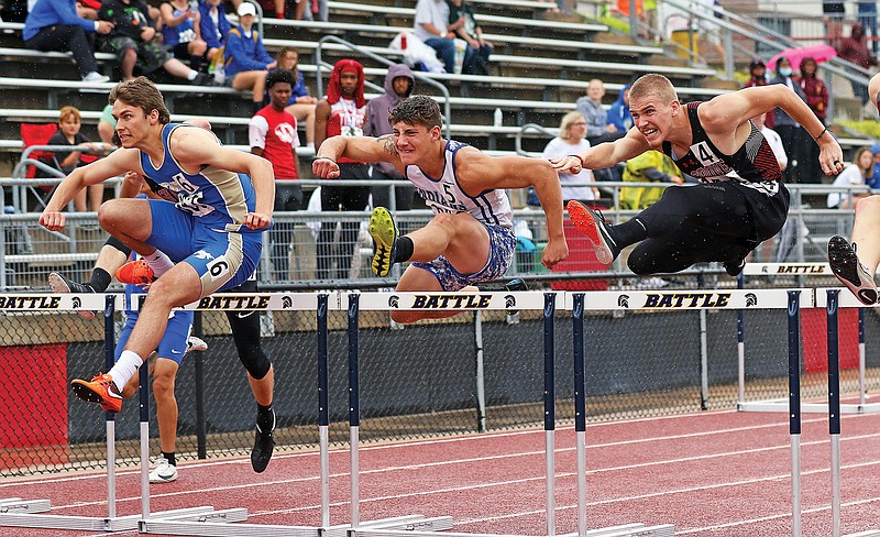 Russellville's Gabrial Little (center) clears a hurdle alongside Rylan Allsup of Hamilton-Penney (left) and Christopher Miller of Ash Grove during the 110-meter hurdles Friday in the Class 2 state track and field championships at Adkins Stadium.