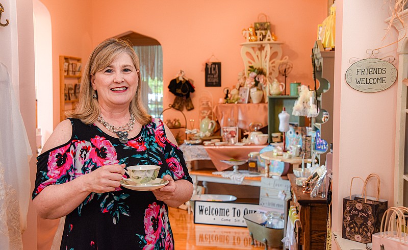 Julie Smith/News Tribune
Deanne Strope poses inside Renee's Teas & Treasures on E. High Street Wednesday. Strope opened the shop a few years ago, shortly before the May 2019 tornado which repairs were then followed by the pandemic.