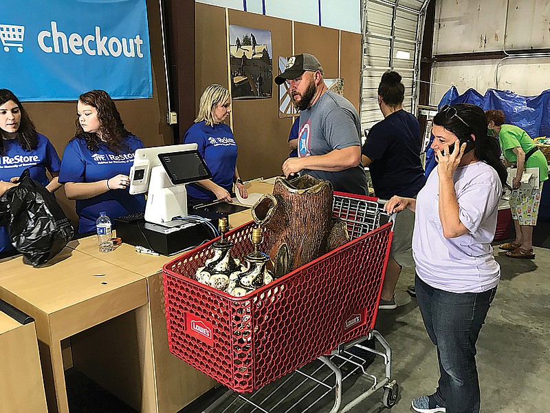 Several hundred residents stopped by Habitat For Humanity's newly open resale store Saturday at 3632 New Boston Road to buy assorted items at the new outlet. Sales proceeds collected will go toward helping Habitat continue financing future home construction projects locally and in the area.