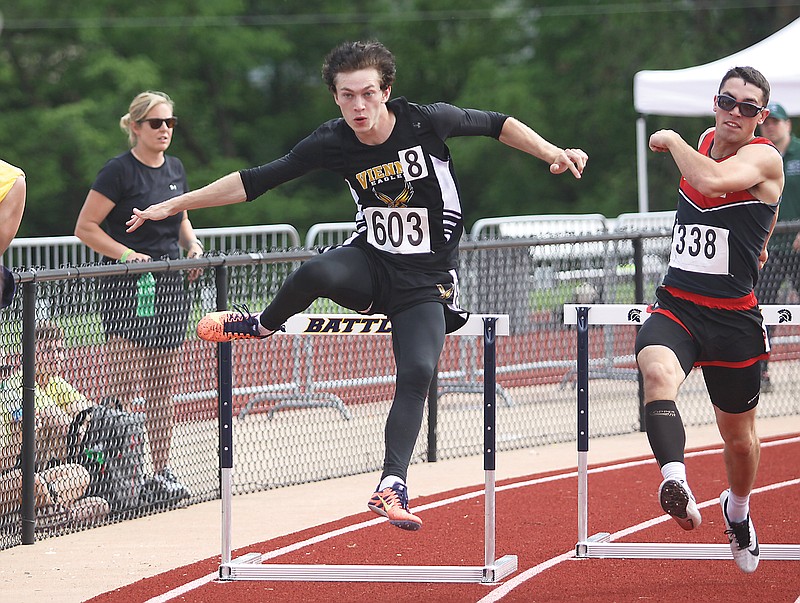 Vienna's Mike Andrews clears a hurdle as he rounds the corner in the 300-meter hurdles Saturday in the Class 1 track and field championships at Adkins Stadium.