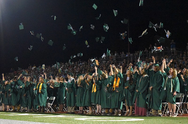 (India Garrish/News Tribune) The class of 2021 Blair Oaks High School graduates throw their caps in the air as Sunday’s ceremony came to a close. 