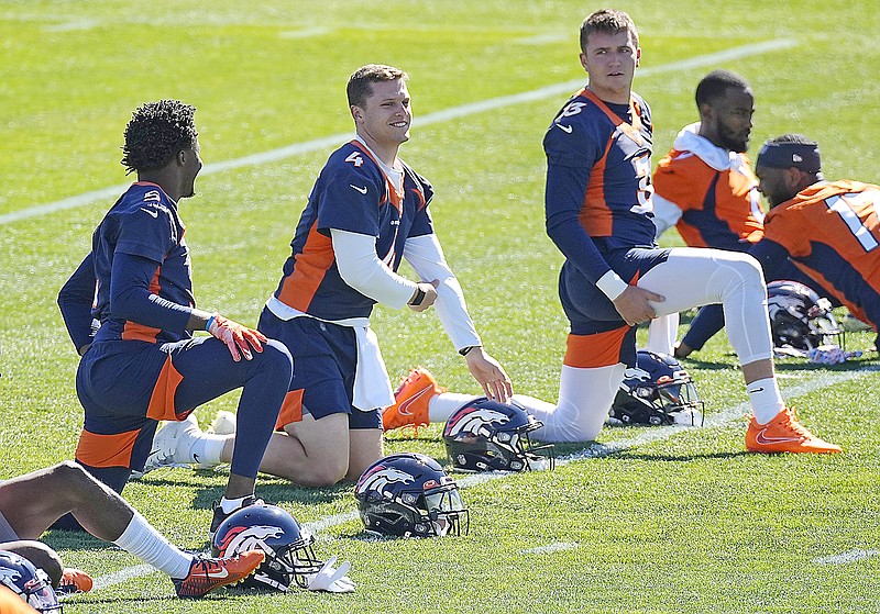 From left, Broncos quarterbacks Teddy Bridgewater, Brett Rypien and Drew Lock talk while stretching Monday during the Broncos' OTAs at the team's headquarters in Englewood, Colo.