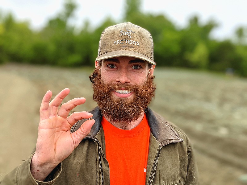 Christian Liden, of Poulsbo, Washington, holds the 2.2-carat diamond he found May 9 at Crater of Diamonds State Park in Murfreesboro, Arkansas, and named Washington Sunshine. Liden and a friend had been traveling across the country mining for the materials for an engagement ring.