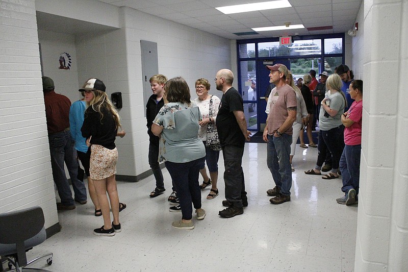 <p>News Tribune/Austin Hornbostel</p><p>Members of the public form a line extending out into the parking lot to sign in at Thursday’s Cole R-1 school board meeting.</p>