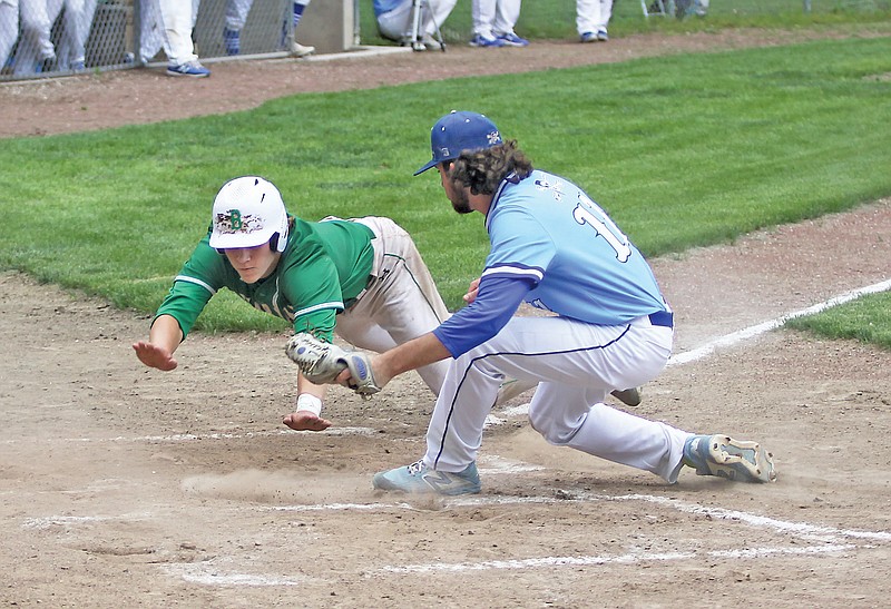 Josh Isaacs of Blair Oaks dives into home plate just ahead of the tag of Boonville pitcher Cody Garner on a wild pitch during the second inning of Tuesday's Class 4 sectional game at Twillman Field in Boonville.