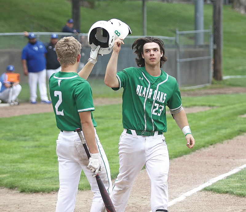 Reid Dudenhoeffer (right) bumps helmets with Blair Oaks teammate Wil Libbert after hit a two-run home run during the second inning of Tuesday's Class 4 sectional game against Boonville at Twillman Field in Boonville.