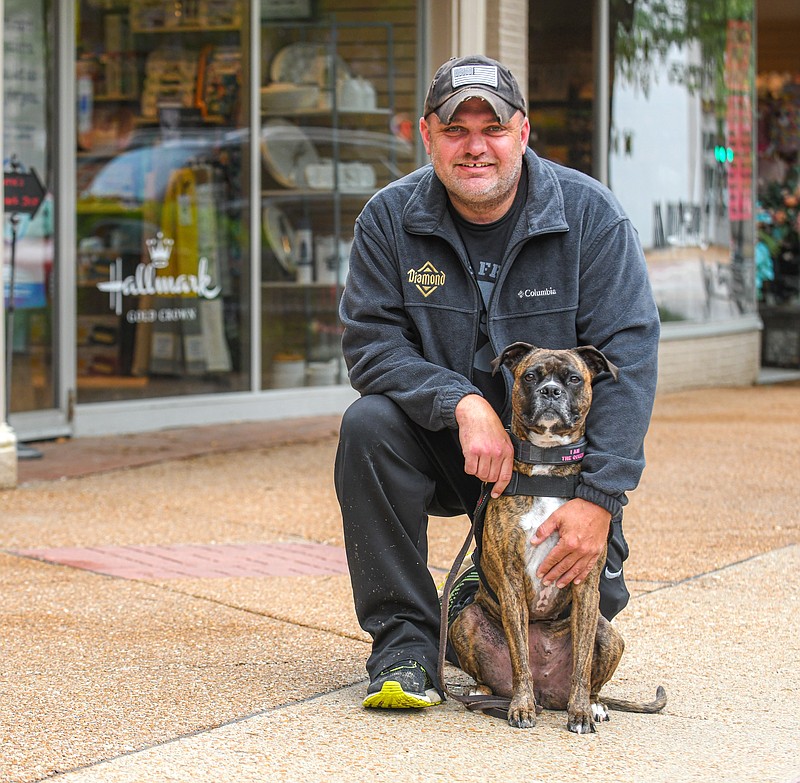 Julie Smith/News Tribune
Jason Howe poses with his service dog, Sobee, in downtown Jefferson CIty. 