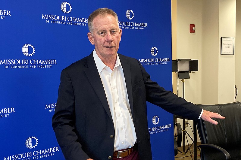 Dan Mehan, president and CEO of the Missouri Chamber of Commerce and Industry, stands against a backdrop that the chamber has used for virtual meetings during the coronavirus pandemic at its office in Jefferson City, Missouri, on May 24, 2021. (AP Photo/David A. Lieb)