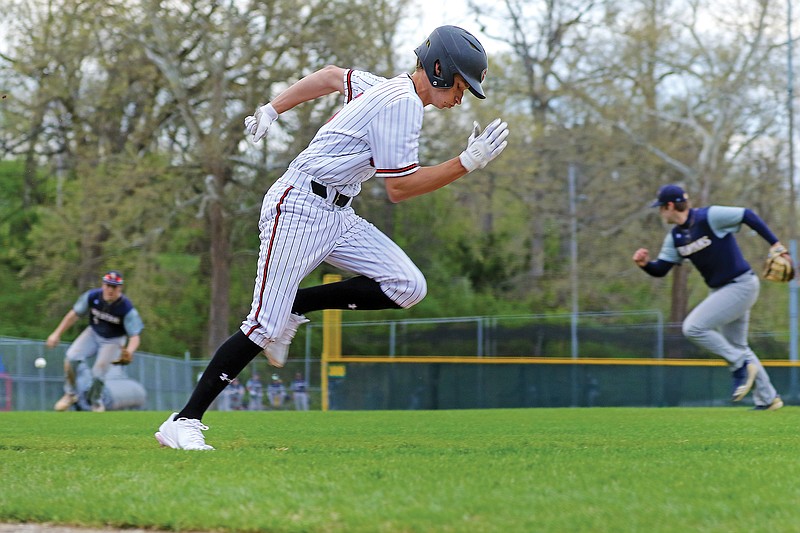 Tanner Schmitz of Jefferson City runs down the line toward first base after bunting to the third baseman during a game this season against Battle at Vivion Field.