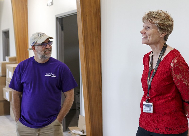 Liv Paggiarino/News Tribune

Catholic Charities Executive Director Dan Lester and Michelle Bard chat while touring the progress of the new Catholic Charities building on Thursday. 