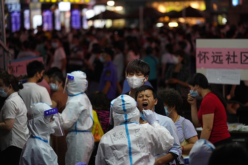 A resident gets tested for coronavirus in the Liwan District in Guangzhou in southern China's Guangdong province on Wednesday May 26, 2021. The southern Chinese city of Guangzhou shut down a neighborhood and ordered its residents to stay home Saturday, May 29, for door-to-door coronavirus testing following an upsurge in infections that has rattled authorities.(AP Photo)