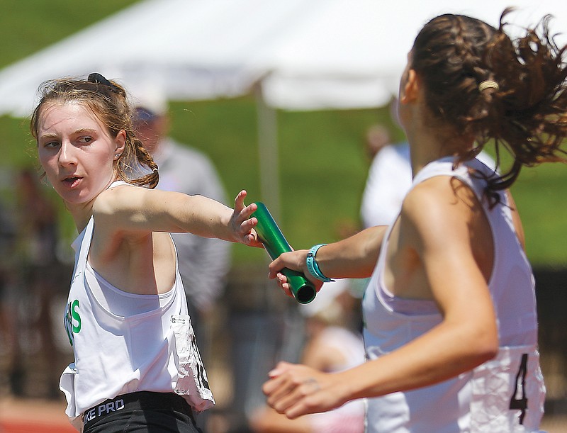 Emily Sporleder of Blair Oaks takes the baton from teammate Ansley Casey during the 4x800-meter relay Saturday at the Class 3 track and field state championships at Adkins Stadium.