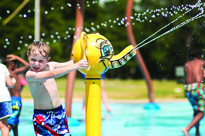 Lincoln Hargrave sprays water at the Rotary Splash Pad in Spring Lake Park on June 30, 2017. 