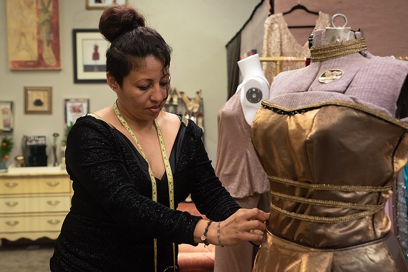 Irma Zuniga adjusts a dress in her shop in downtown Texarkana. Irma, originally from Honduras, has lived in Texarkana for about 10 years. She specializes in dresses, and has a shop for people to come in for fittings as well as peruse pieces she has already made.
