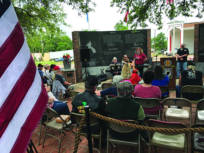 Ashlyn Butler sings to a Memorial Day gathering at the Korea-Vietnam Memorial in downtown Terxarkana. The Vietnam Veterans of America Chapter 278 has been holding its Memorial Day service at the site for the last 38 years.