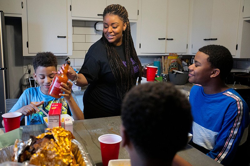 Stevi Knighton makes ramen noodles for her two sons, 10-year-old Ari, left, and 12-year-old Hayden, right, and their friend, Michael Hughes, after school. (Courtney Hergesheimer/The Columbus Dispatch/TNS)