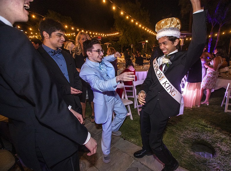Agoura High School senior Jaden Wishengrad, 18, 2nd from right, congratulates Yasper De Jong, 18, right, after he was announced as prom king during the Agoura High School Senior Prom held at Moorpark Country Club in Moorpark, CA on Friday, May 21, 2021. (Mel Melcon/Los Angeles Times/TNS)