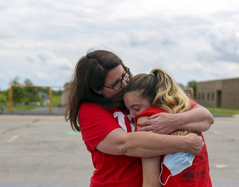 Liv Paggiarino/News Tribune

Joni Henderson kisses the top of her former student Jaselynn Saffeels’ head on Tuesday on the playground of Callaway Hills Elementary, while taking a break from cleaning out Henderson’s classroom. Henderson retired this year, after nearly three decades of teaching fourth and fifth graders at Moreau Heights Elementary and Callaway Hills Elementary.