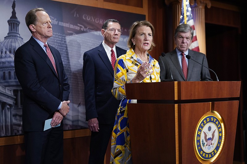 Sen. Shelley Moore Capito speaks at the Capitol in Washington, Thursday, May 27, 2021, as from left, Sen. Pat Toomey, R-Pa., Sen. Barrasso, R-Wy. and Sen. Roy Blunt, R-Mo., look on. Republican senators outlined a $928 billion infrastructure proposal Thursday, a counteroffer to President Joe Biden's more sweeping plan as the two sides struggle to negotiate a bipartisan compromise and remain far apart on how to pay for the massive spending. (AP Photo/J. Scott Applewhite)
