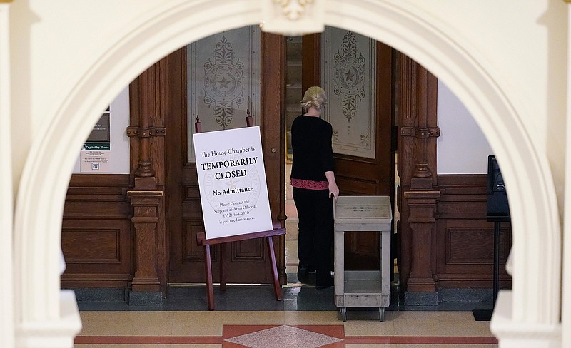 A "Temporarily Closed" sign blocks the entry to the House Chamber at the State Capitol, Tuesday, June 1, 2021, in Austin, Texas. The Texas Legislature closed out its regular session Monday, but are expected to return for a special session after Texas Democrats blocked one of the nation's most restrictive new voting laws with a walkout. (AP Photo/Eric Gay)