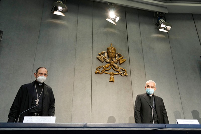 Mons. Filippo Iannone, right, and Mons. Juan Ignacio Arrieta Ochoa de Chinchetru arrive for a press conference to illustrate changes in the Church's Canon law, at the Vatican, Tuesday, June 1, 2021. Pope Francis has changed church law to explicitly criminalize the sexual abuse of adults by priests who abuse their authority and to say that laypeople who hold church office can be sanctioned for similar sex crimes. (AP Photo/Andrew Medichini)