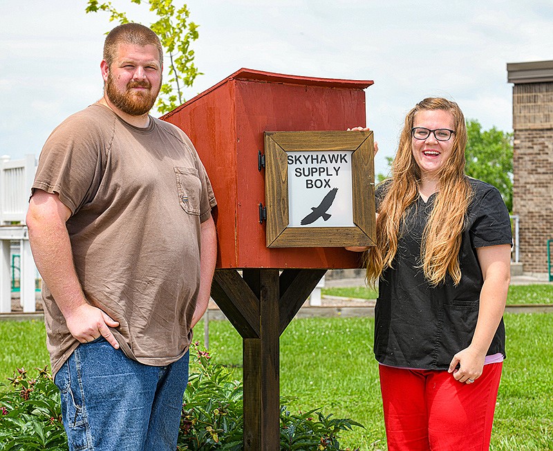 John and Brittany Wade stand next to the latest Blessing Box they've installed, this one located at Cedar Hill Elementary School. The boxes contain non-perishable food items, hygiene products and other items one may not be able to afford and are free to whomever needs them.