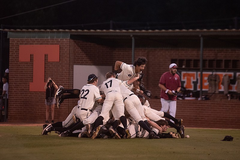 Pleasant Grove players pile on top of each other after winning their game against Liberty-Eylau, the second game of the Region II-4A finals, Thursday night. The win allows the team to advance to state.
