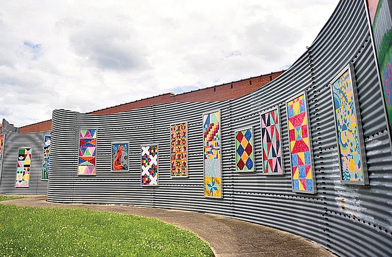 Paintings line the ArtSpark ArtWall outside the Regional Arts Center in downtown Texarkana. The Texarkana Regional Arts and Humanities Council will offer an Art Wall children's art camp this summer. The 1894 Gallery will host a children's Global Art Camp.