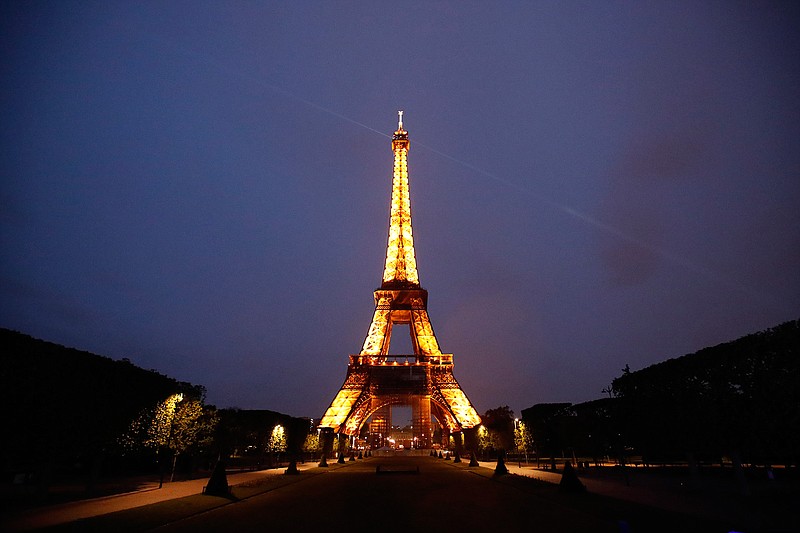 The Eiffel Tower is illuminated in Paris, Tuesday, May 25, 2021. France is putting itself back on the menu as a destination for international tourists who have had coronavirus jabs. The relaxed rules will kick in from Wednesday, offering a boost for France's tourism sector. Tourism will still not be possible from countries wrestling with virus surges and worrisome variants, including India, South Africa and Brazil. (AP Photo/Francois Mori)