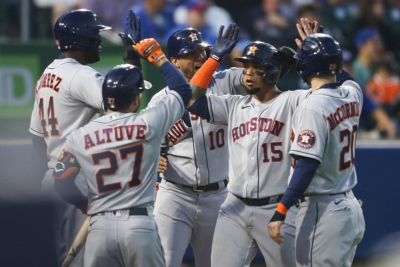 Houston Astros' Martin Maldonado (15) celebrates with Yuli Gurriel (10), Chas McCormick (20), Yordan Alvarez (44), and Jose Altuve (27) after hitting a grand slam during the sixth inning of the team's baseball game against the Toronto Blue Jays in Buffalo, N.Y., Friday, June 4, 2021. (AP Photo/Joshua Bessex)