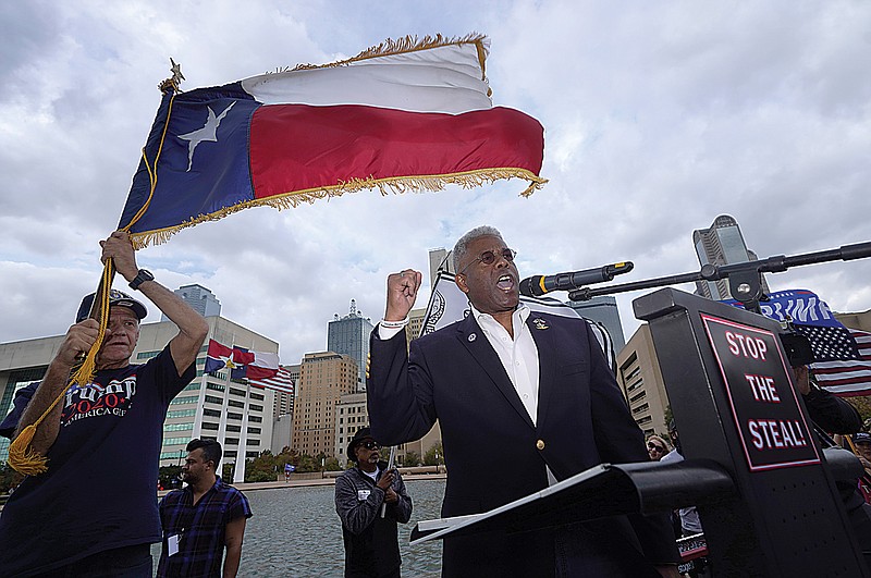 In this Nov. 14, 2020, file photo, Texas GOP chairman Allen West, right, speaks to supporters of President Donald Trump during a rally in front of City Hall in Dallas. West announced Friday he was stepping down less than a year into a combative tenure of challenging his own party's top leaders, including leading a protest outside Republican Gov. Greg Abbott's mansion.