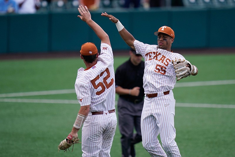 Texas pitcher Zach Zubia (52) and third baseman Camryn Williams (55) celebrate after their win over Southern in an NCAA regional tournament college baseball game, Friday, June 4, 2021, in Austin, Texas. (AP Photo/Eric Gay)