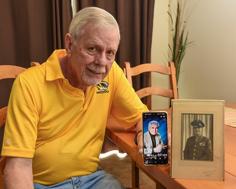 Julie Smith/News TribuneBrent Hardy shows a photograph of his father and one of his brother whom he was able to contact a couple of years ago and will meet in person on June 30.