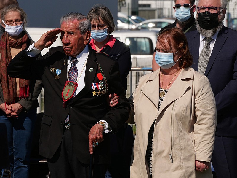 Charles Shay, the 96-year-old native American from Indian Island, Maine, salutes during a D-Day ceremony in Carentan, Normandy, Friday, June 4, 2021. In a small Normandy town where paratroopers landed in the early hours of D-Day, applauds broke the silence to honor Charles Shay. He was the only veteran to attend the ceremony in Carentan commemorating the 77th anniversary of the assault that led to the end World War II. Shay was a 19-year-old U.S. Army medic when he landed on Omaha Beach. (AP Photo/Nicolas Garriga)