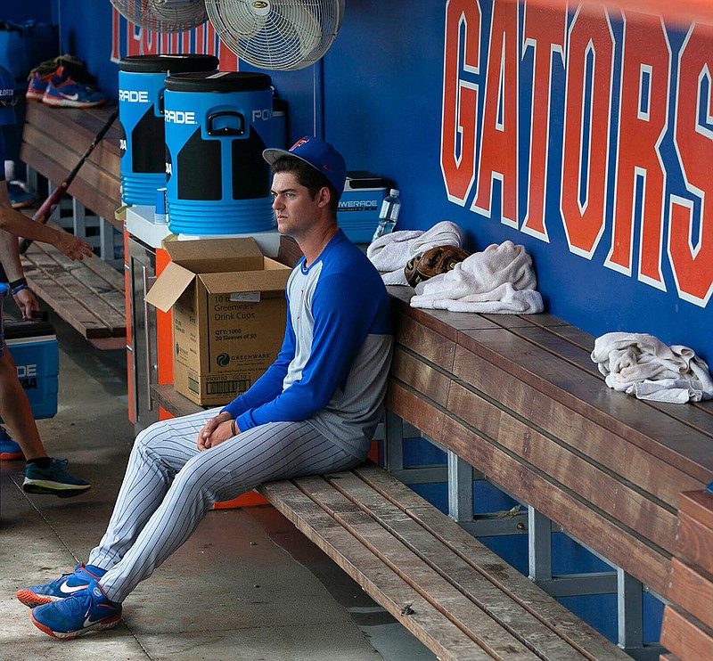 Florida's Tommy Mace (47) sits in the dugout following to the Gators 19-1 loss to South Alabama in an NCAA regional tournament college baseball game against South Alabama at Florida Ballpark, Saturday, June 5, 2021, in Gainesville, Fla. (Cyndi Chambers/Ocala Star-Banner via AP)