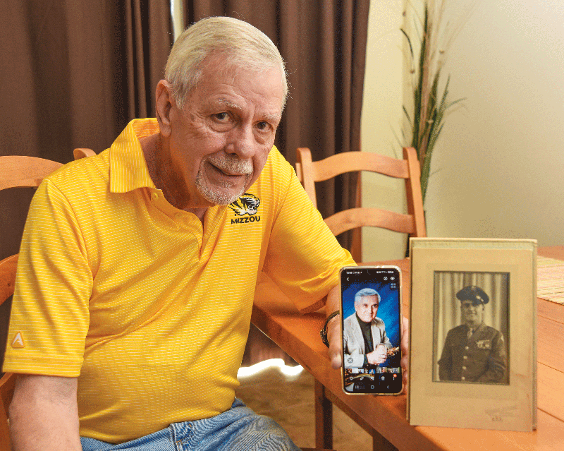 Brent Hardy shows a photograph of his father and one of his brother whom he was able to contact a couple of years ago and will meet in person June 30.