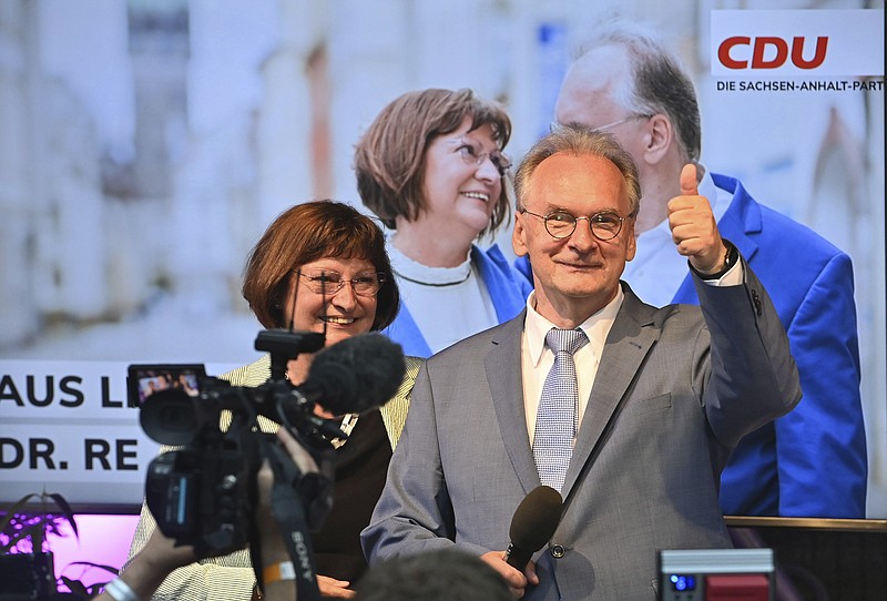 Saxony-Anhalt state governor Reiner Haseloff of Merkel's Christian Democratic Union party, CDU, and his wife Gabriele react, at the CDU election party, after the state election in Magdeburg, Germany, Sunday, June 6, 2021 . The election for the new state parliament in Saxony-Anhalt was the last state election before the federal election in September 2021. (Bernd Von Jutrczenka/dpa via AP)