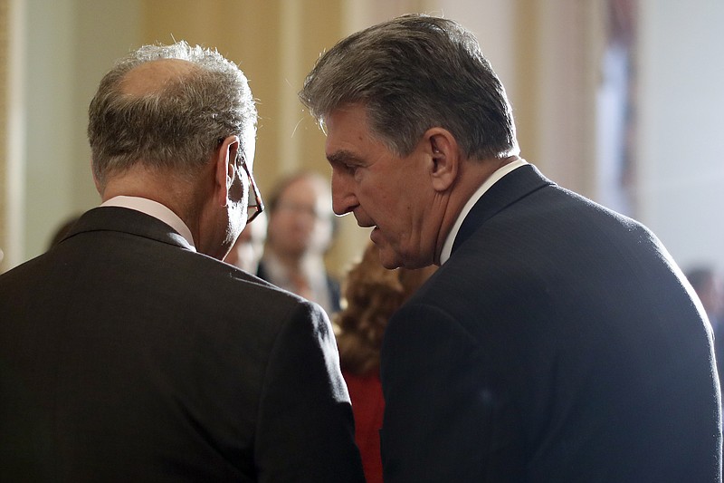 FILE - In this May 2, 2017, file photo, Sen. Joe Manchin, D-W.Va., right, speaks to then-Senate Minority Leader Charles Schumer, D-N.Y. during a news conference on Capitol Hill in Washington. Schumer warned his Democratic colleagues that June will "test our resolve" as senators return Monday to consider infrastructure, voting rights and other priorities. Six months into Democrats' hold on Washington, the senators are under enormous pressure to make gains on Democrats' campaign promises. (AP Photo/Carolyn Kaster, File)