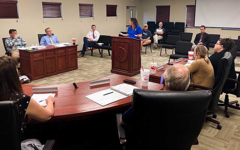 (India Garrish/Fulton Sun) Republic Services Account Manager Lillian Kinard, center, speaks Tuesday to the Holts Summit Board of Alderman about the city's options for recycling at their monthly meeting.