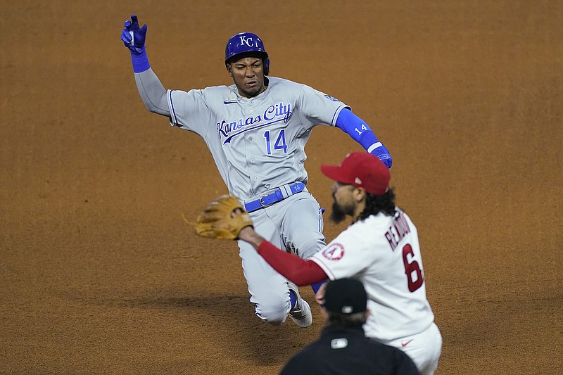 Edward Olivares of the Royals slides in to third base ahead of a throw to Angels third baseman Anthony Rendon (6) during the fifth inning of Tuesday night's game in Los Angeles.