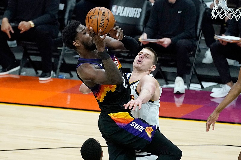 Phoenix Suns center Deandre Ayton is fouled by Denver Nuggets center Nikola Jokic, right, during the second half of Game 1 of an NBA basketball second-round playoff series, Monday, June 7, 2021, in Phoenix. (AP Photo/Matt York)